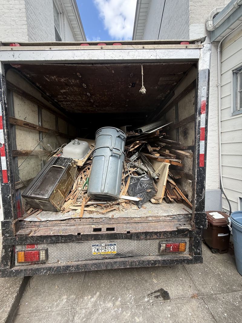 Old water heater and household items loaded in the JR Hauling truck for disposal
