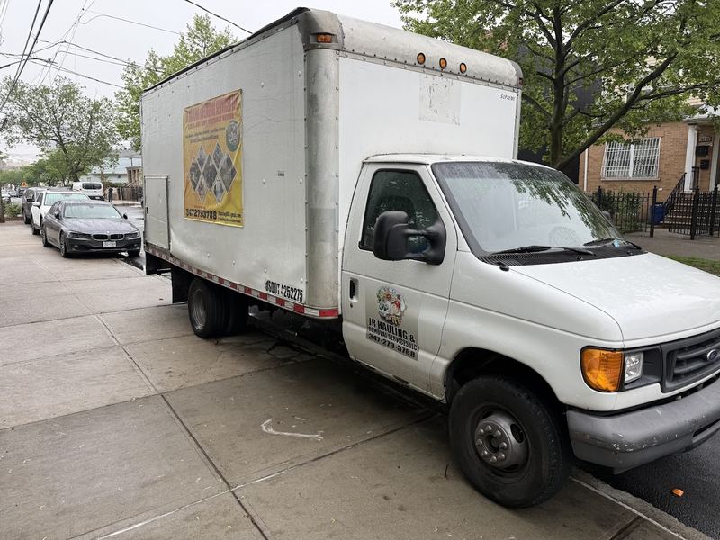 JR Hauling and Removal Services box truck parked on a Queens street