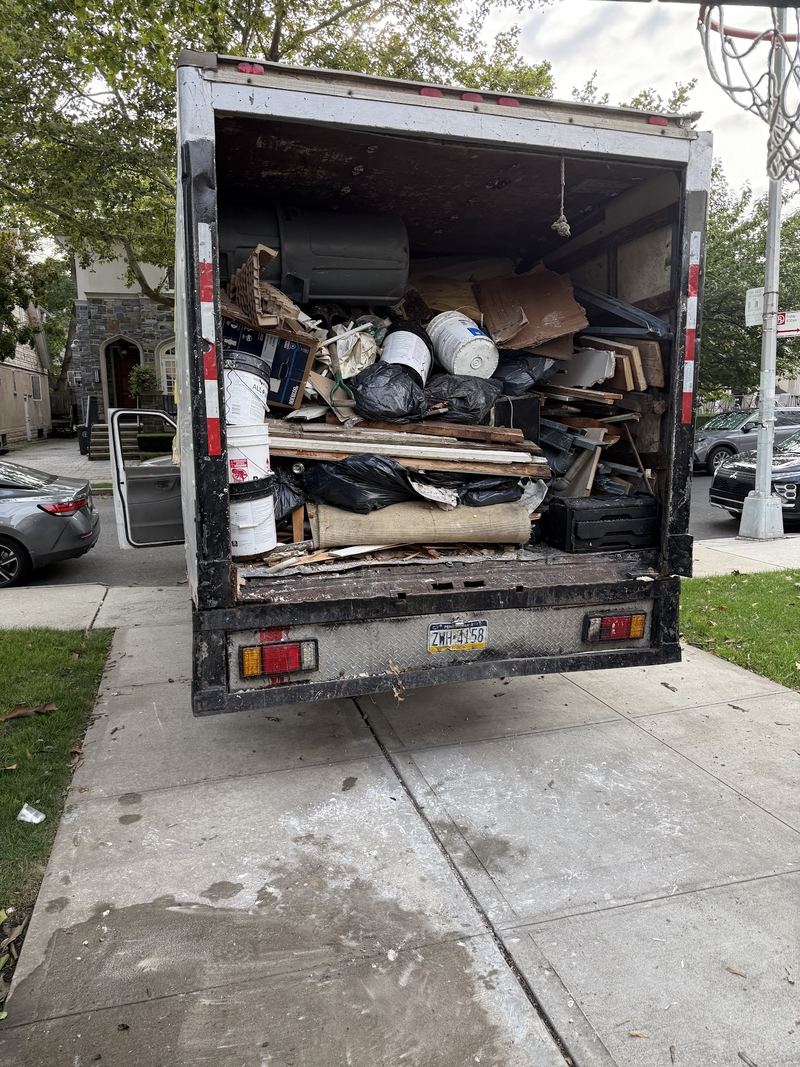 JR Hauling truck loaded with items from a combined clean out and haul-away